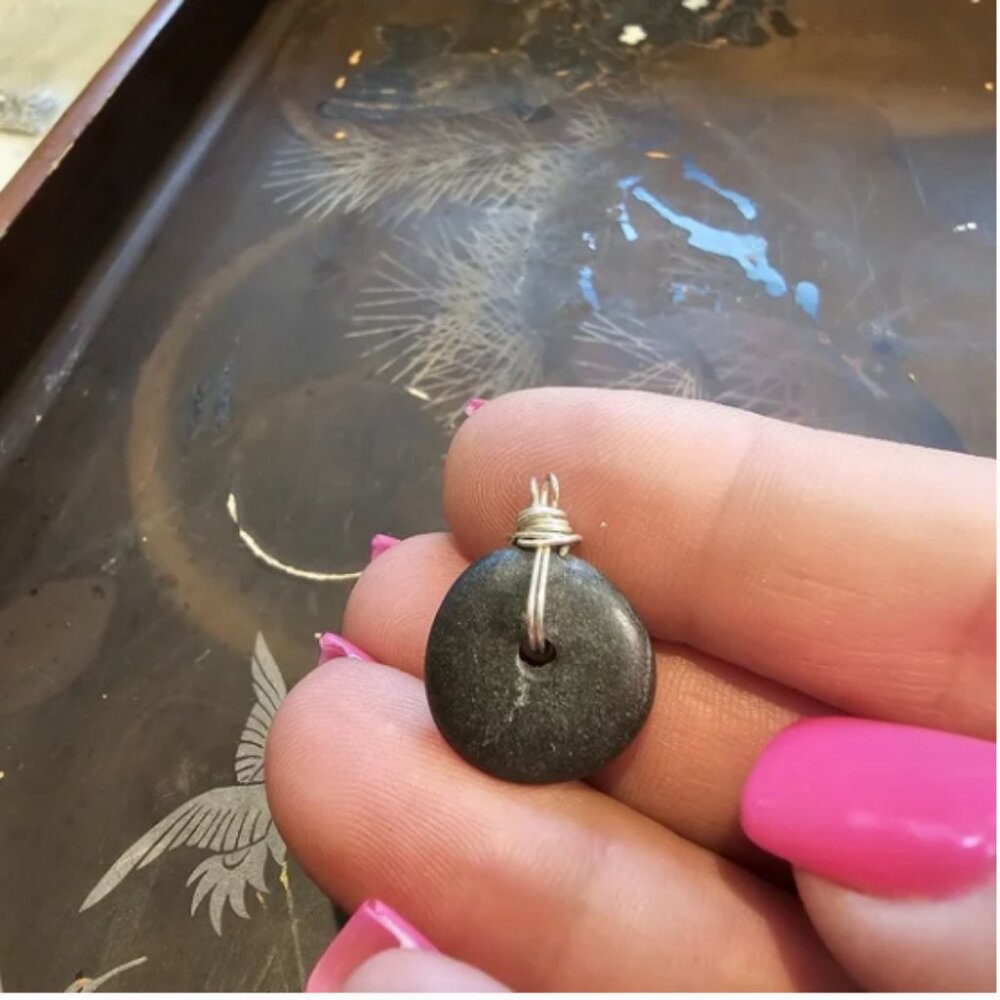 Small stone pendant with silver wire bale and wrap.